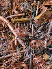 Copper scrap tubes and wire ready to be recycled, portrait view 