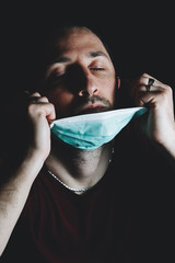Coronavirus, covid 19. A man fighting under a mask.