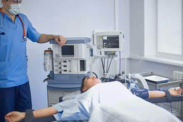 Several doctors surrounding patient on operation table during their work. Team surgeons at work in operating room