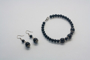 Set of earrings and bracelet on white background.  Female accessories, decorative ornaments and jewelry. Fashion and style concept.