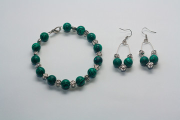 Set of earrings and bracelet on white background.  Female accessories, decorative ornaments and jewelry. Fashion and style concept.