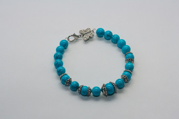 Turquoise bracelet on white background.  Female accessories, decorative ornaments and jewelry. Fashion and style concept.