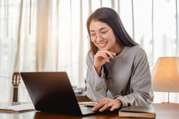 Woman work from home have a coffee cup beside wait epidemic situation to improve soon at home....
