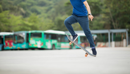 Fototapeta premium Skateboarder legs skateboarding at outdoors