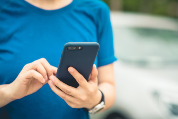Asian woman using smartphone outdoors