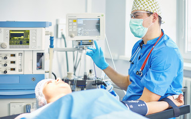 Several doctors surrounding patient on operation table during their work. Team surgeons at work in operating room