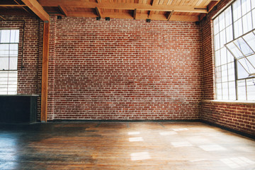 Brick wall and wooden floored space