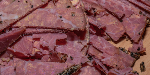 Black peppercorn roast beef. Close-up macro photo of julian chopped roast beef on yellow coffee...