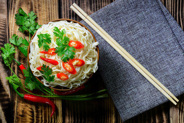 line  noodle  chopsticks and coriander fresh chilli have smoke ready eat. place on wood table have pattern luxury