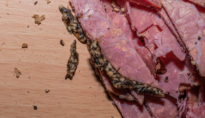 Black peppercorn roast beef. Close-up macro photo of julian chopped roast beef on yellow coffee...