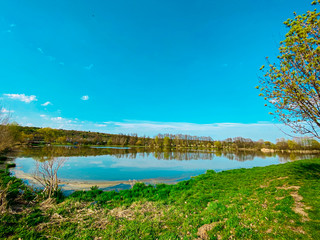 Fototapeta na wymiar Spring walk around the lake in the sunshine.