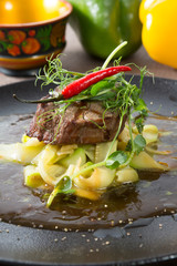 Prepared beef steak served with zucchini
