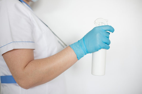 Nurse holding antibacterial fluid for disinfection.