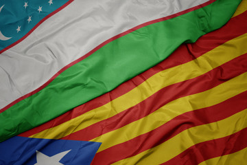 waving colorful flag of catalonia and national flag of uzbekistan.