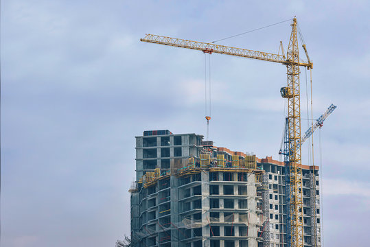 construction of a new high-rise multi-storey building for a large number of apartments. two tower cranes are working at the construction site