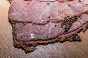 Black peppercorn roast beef. Close-up macro photo of julian chopped roast beef on yellow coffee...