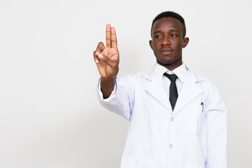 Portrait of young African man doctor touching something