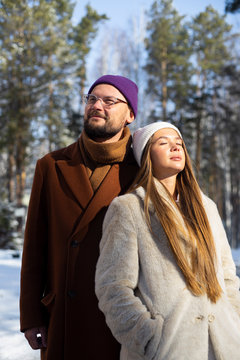 young couple enjoying winter park 