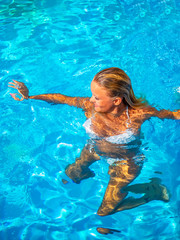 woman in luxury spa resort near the swimming pool.