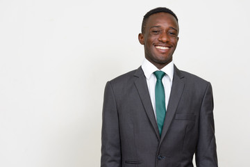 Portrait of happy young African businessman in suit smiling