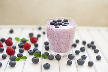 Fototapeta na wymiar Healthy breakfast of smoothie, dessert, yogurt or milkshake with fresh berries on whtite wooden table 