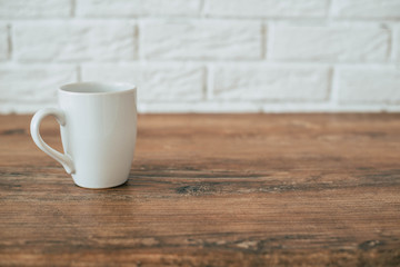 White cup on a wooden table