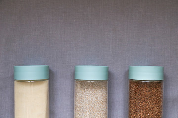 cereals on a linen gray tablecloth, buckwheat, semolina, wheat