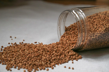cereals on a linen gray tablecloth, buckwheat, semolina, wheat