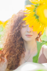 The red hair girl in sunflowers field