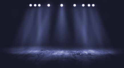 Dark stage with spotlight background.