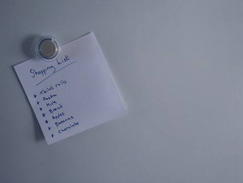 Hand Written Shopping List On Fridge Door