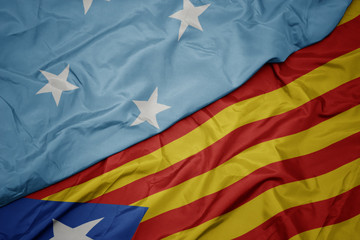 Fototapeta premium waving colorful flag of catalonia and national flag of Federated States of Micronesia .
