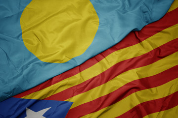waving colorful flag of catalonia and national flag of Palau .