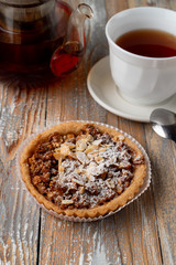Close up of a nuts gluten free tartlet with honey, almonds and walnut