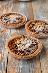 Close up of a nuts gluten free tartlet with honey, almonds and walnut