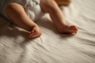 Little foot of child on the bed
