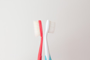  Red and blue toothbrushes on a gray background. Old and new toothbrush. Oral hygiene concept. copy space for text
