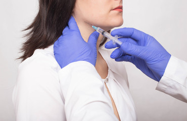 Taking a biopsy from a girl from the salivary gland to check for a benign or malignant tumor, cancer