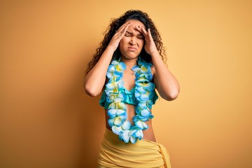 Young beautiful american woman on vacation wearing bikini and hawaiian lei flowers suffering from...