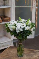 Flower bouquet in a vase in interior
