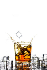 Whiskey with ice cubes.Isolated shot of whiskey.Glass of scotch and ice cubes on a white background.