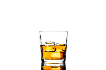 Whiskey with ice cubes.Isolated shot of whiskey.Glass of scotch and ice cubes on a white background.