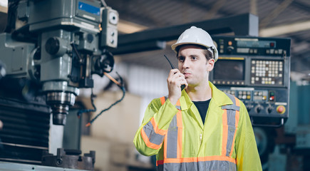 profession technician engineer using walkie-talkie in factory