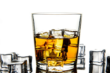 Whiskey with ice cubes.Isolated shot of whiskey.Glass of scotch and ice cubes on a white background.