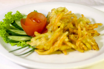 vegetable tempura with tomato salad, cucumber and lettuce, selective focus