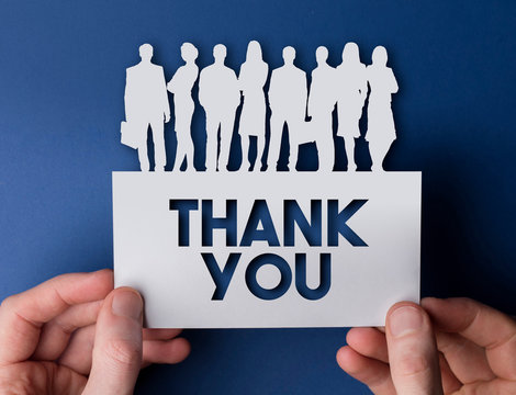 Hands holding a thank you white card business team people sign