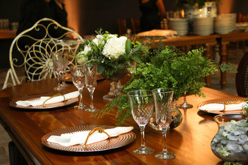 buffet table set up and decorated for the event with dishes, cutlery, napkins, glasses and bowls