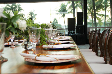 buffet table set up and decorated for the event with dishes, cutlery, napkins, glasses and bowls