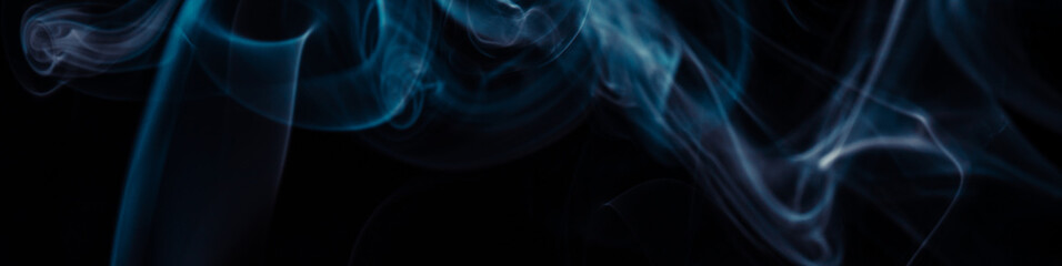 Blue smoke on black background