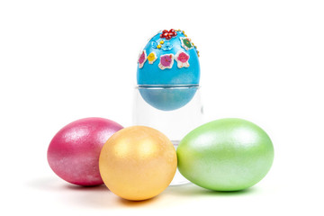 colorful eggs in glass on white